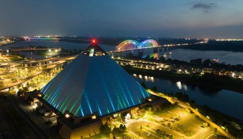 Aerial night view of the Bass Pro Pyramid, Mighty Lights bridge and Mississippi River.