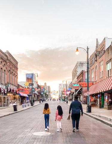 Family strolling Beale Street at sunset | Spring Break Family