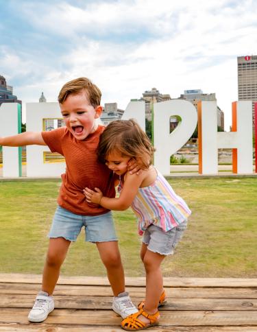 Kids in front of the Mud Island Memphis Sign 