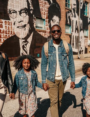 Family in front of National Civil Rights Museum mural  