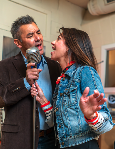 couple sings into mic at sun studio