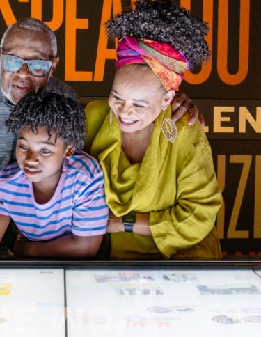 Grandparents and grandson enjoying a National Civil Rights Museum exhibit 
