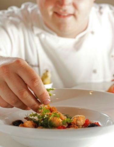 Chef Kelly English putting the final touches on a dish; Justin Fox Burks Chef Kelly English putting the final touches on a dish; Justin Fox Burks