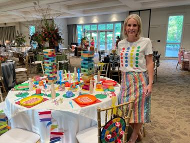 woman poses with table that is design as game theme
