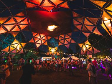 The Incendia Dome at Mempho Music Fest glows at night, crowds dancing within it.