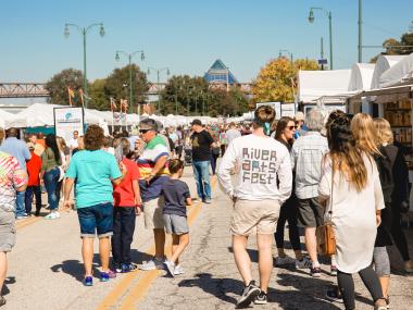 Festivalgoers walking through RiverArtsFest in downtown Memphis