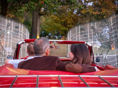 A couple arrives at the gates of Graceland in a convertible