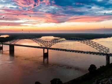 Hernando de Soto bridge over the Mississippi River at sunset.