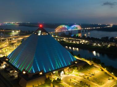 Aerial night view of the Bass Pro Pyramid, Mighty Lights bridge and Mississippi River.