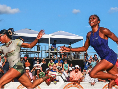 Two African American women running next to each other in a race