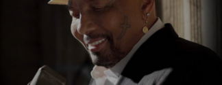 Aaron Neville smiling with microphone