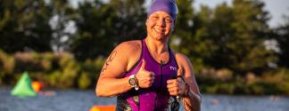 Racer flashes a thumbs up after exiting lake
