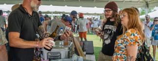 brewery rep pours samples for Brewfest patrons