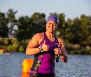 Racer flashes a thumbs up after exiting lake