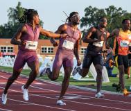 Four men running on a track