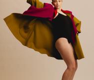 Ballerina in black leotard with red coat