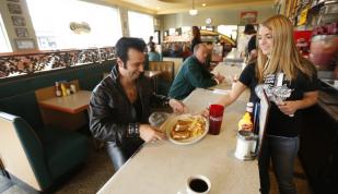 Elvis Tribute Artist enjoys a meal at The Arcade Restaurant, one of Elvis' favorite spots. Photo