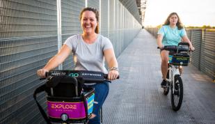 Woman using Explore Bike Share on Big River Crossing. Photo: Craig Thompson Photo