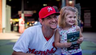 Redbirds player with fan. Photo by Craig Thompson Photo