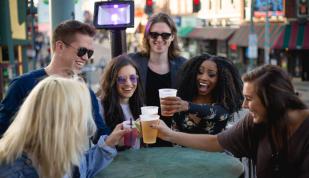 Friends cheersing on the rooftop patio at Alfred's on Beale. Photo