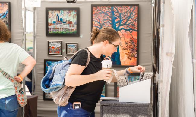 Someone shopping for art at RiverArtsFest.