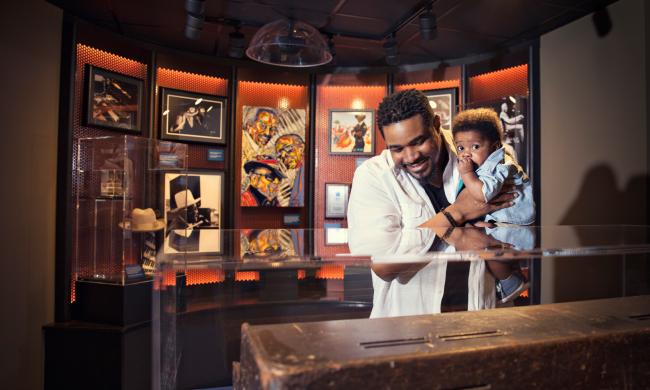 Father and son in front of an exhibit at the Blues Hall of Fame