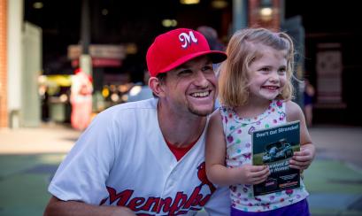 Memphis Redbirds player with a young fan. | Craig Thompson