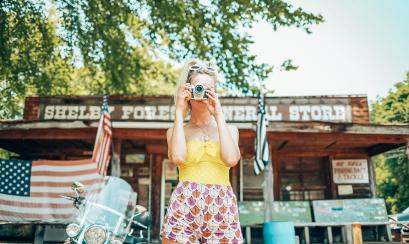 Girl snapping a photo in front of Shelby Forest General Store in Millington near Memphis | Oui We Girl