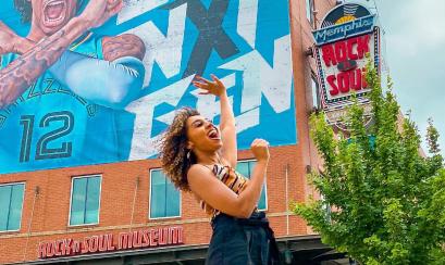 visitor in front of rock n soul with ja morant poster