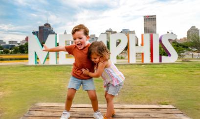 Kids in front of the Mud Island Memphis Sign