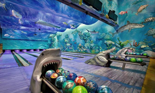 Shark head bowling ball dispenser in blue and green bowling alley at The Fishbowl at the Pyramid.