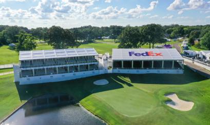 aerial shot of golf course with Fedex bleachers/booths next to hole