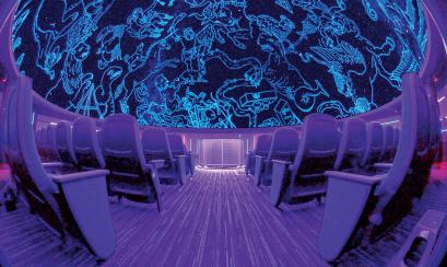 Wide shot of planetarium at MoSH with empty seats and ceiling lit up