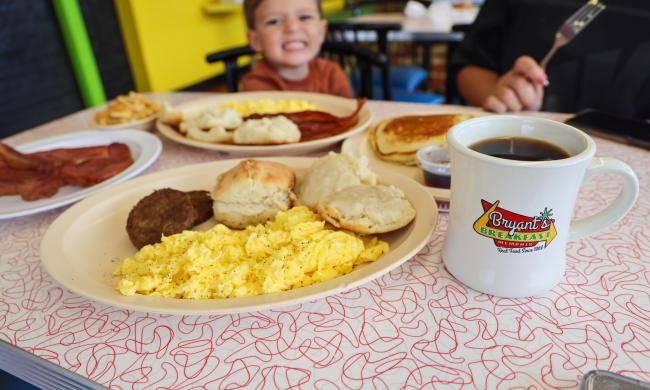 table of breakfast food on table with Bryant's coffee mug
