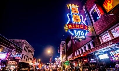 nighttime view of beale street with neon signs lit up