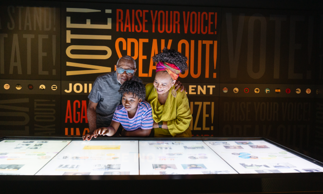 A family explores an interactive exhibit at Memphis' National Civil Rights Museum.
