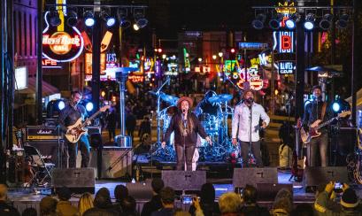 A band performs a concert outside at night on Beale Street in Memphis, Tennessee