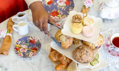 afternoon tea setup with tea pots and treats