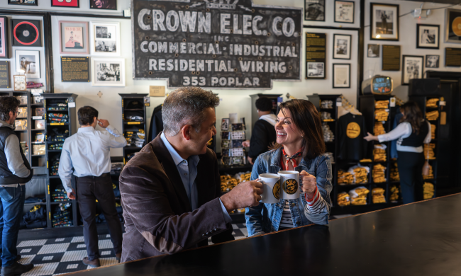 couple cheers with coffee inside sun studio