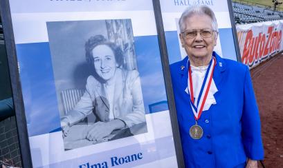 Elma Roane poses with her photo at induction ceremony
