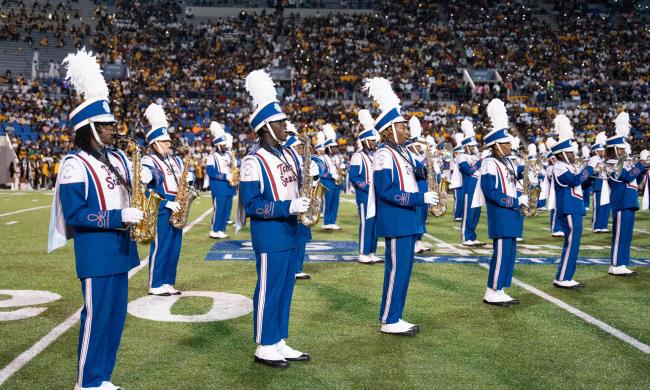 Marching band performing on the field at the Southern Heritage Classic.