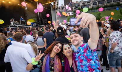 people pose for photo with stage in front of stage at RiverBeat Music Festival
