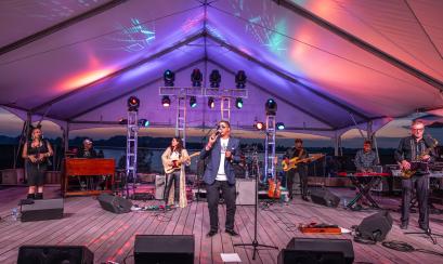 band performs on stage at RiverBeat Music Festival