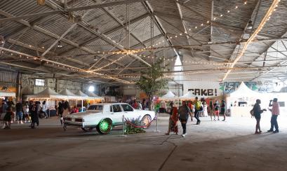 vendors set up at TONE Juneteenth event with 70s Cadillac on display