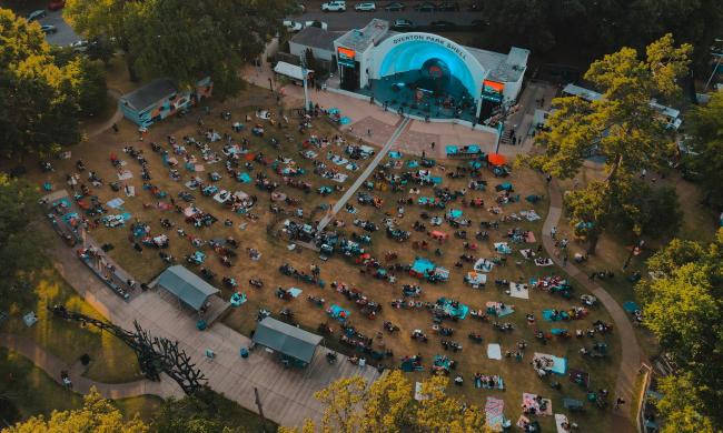 Aerial photo of concert at Overton Park Shell with lawn full of people.