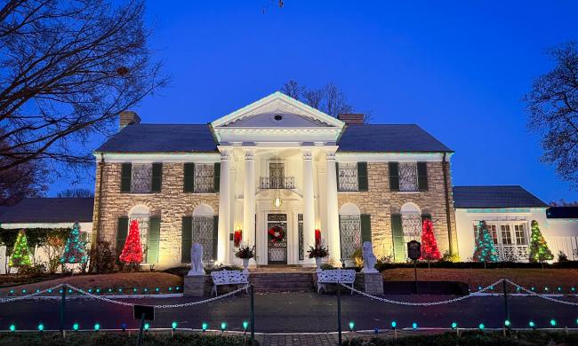 Graceland decorated in Christmas lights.