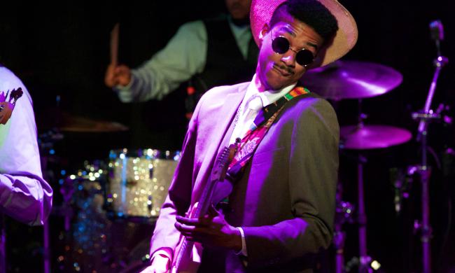 A blues guitarist playing in the International Blues Challenge.