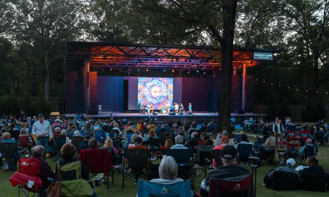 people sitting in lawn chairs watching band at The Grove GPAC concert venue