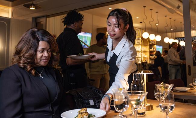 waitress sets dish down in front of of guest at Felicia suzanne's