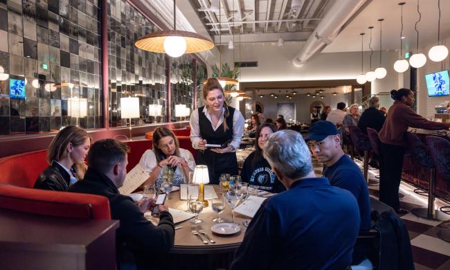 Waitress takes order at table inside Felicia Suzanne's dining room.